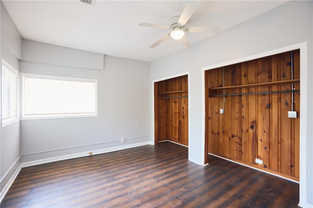 887 Myrtle Street Northeast, Unit 5 Atlanta, GA 30309 - Photo 7 of 11 an empty room with wooden floor closet and windows