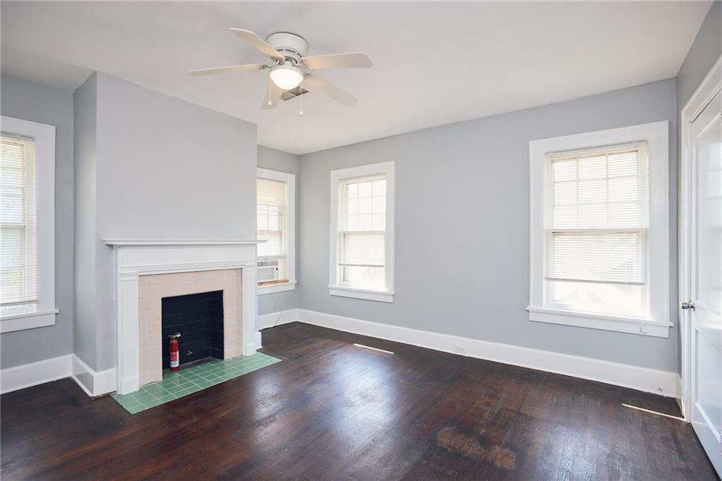 887 Myrtle Street Northeast, Unit 5 Atlanta, GA 30309 - Photo 9 of 11 a view of an empty room with wooden floor fireplace and a window