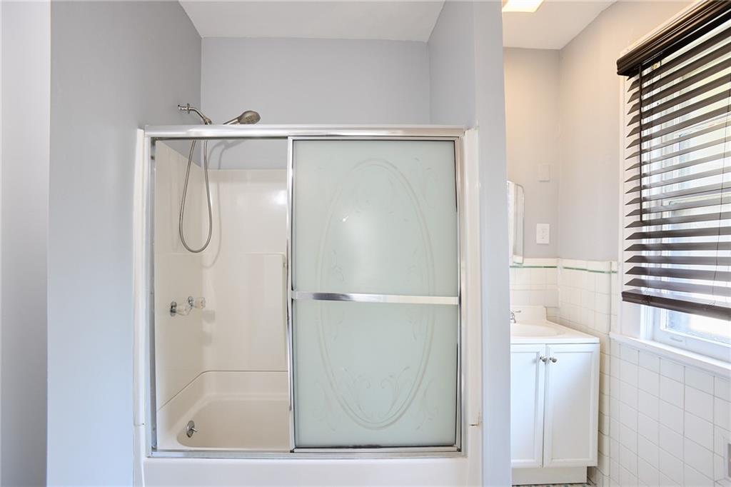 887 Myrtle Street Northeast, Unit 5 Atlanta, GA 30309 - Photo 10 of 11 a bathroom with a glass shower door