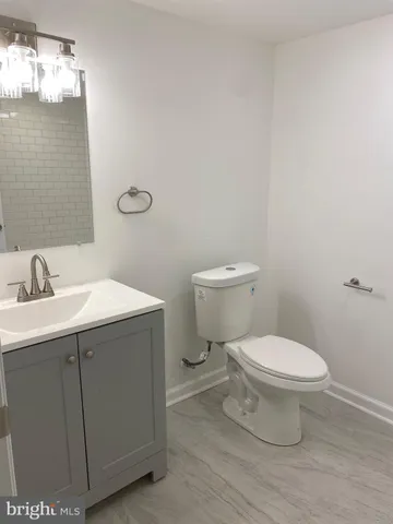 a white bath tub sitting next to a shower