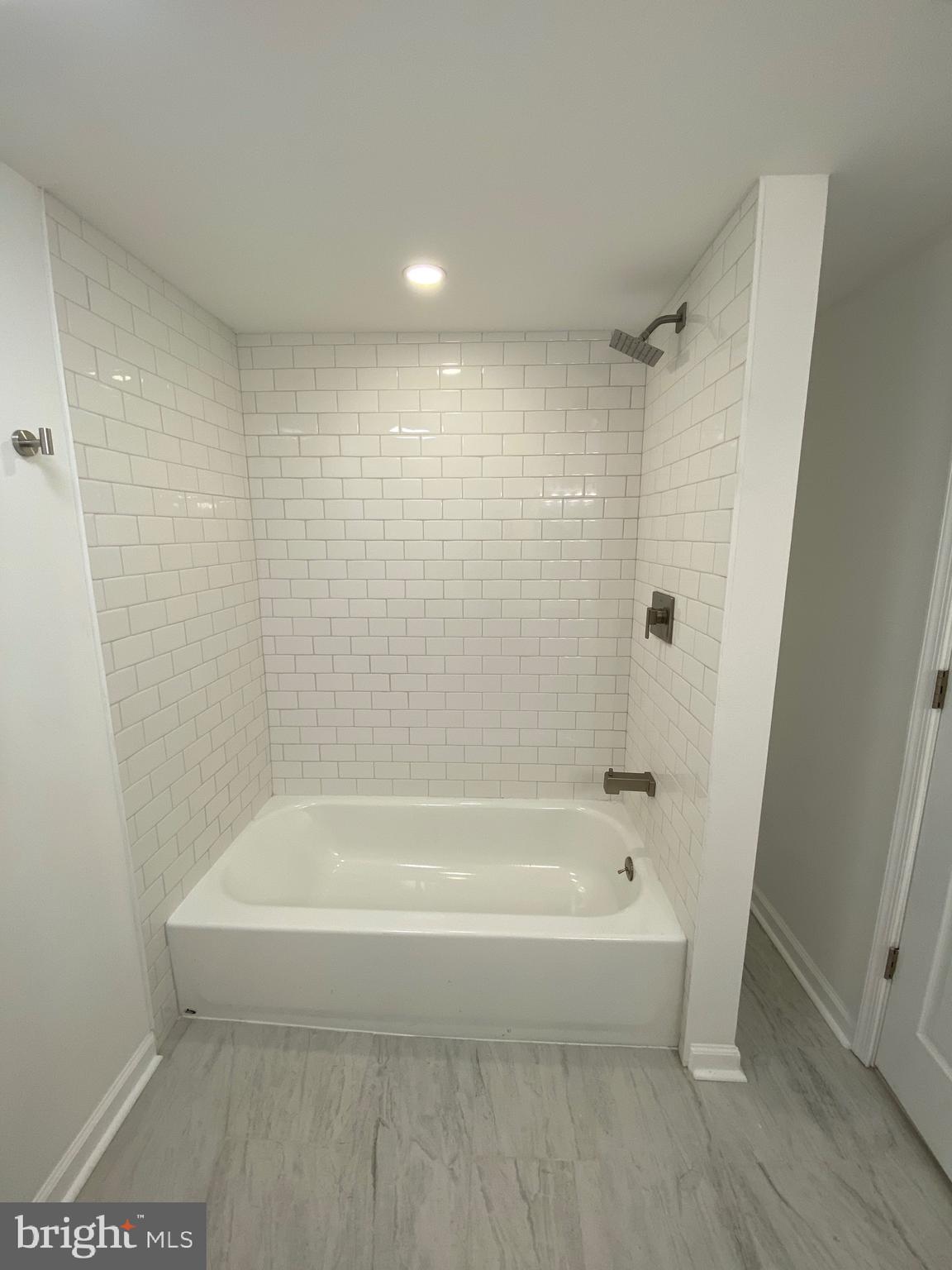45 East High Street, Unit 1ST FLOOR/3 BEDROOM Pottstown, PA 19464 - Photo 18 of 25 a white bath tub sitting next to a shower