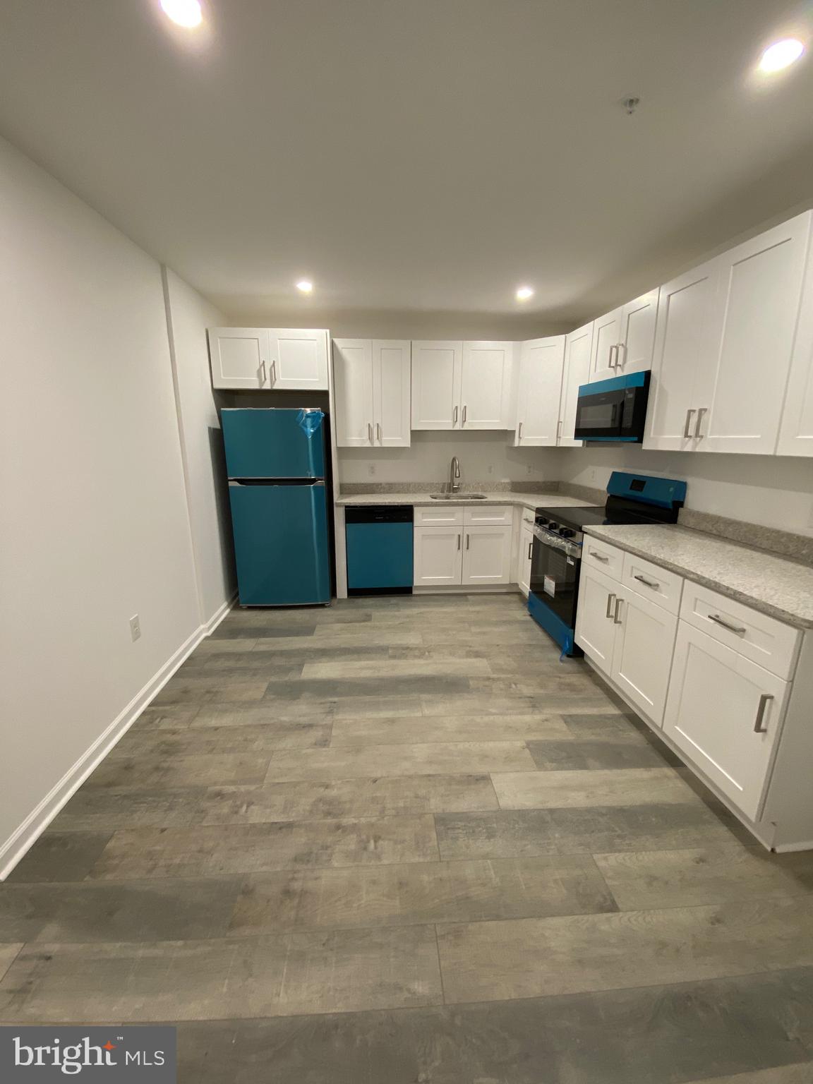 45 East High Street, Unit 1ST FLOOR/3 BEDROOM Pottstown, PA 19464 - Photo 8 of 25 a kitchen with stainless steel appliances granite countertop a refrigerator sink and cabinets