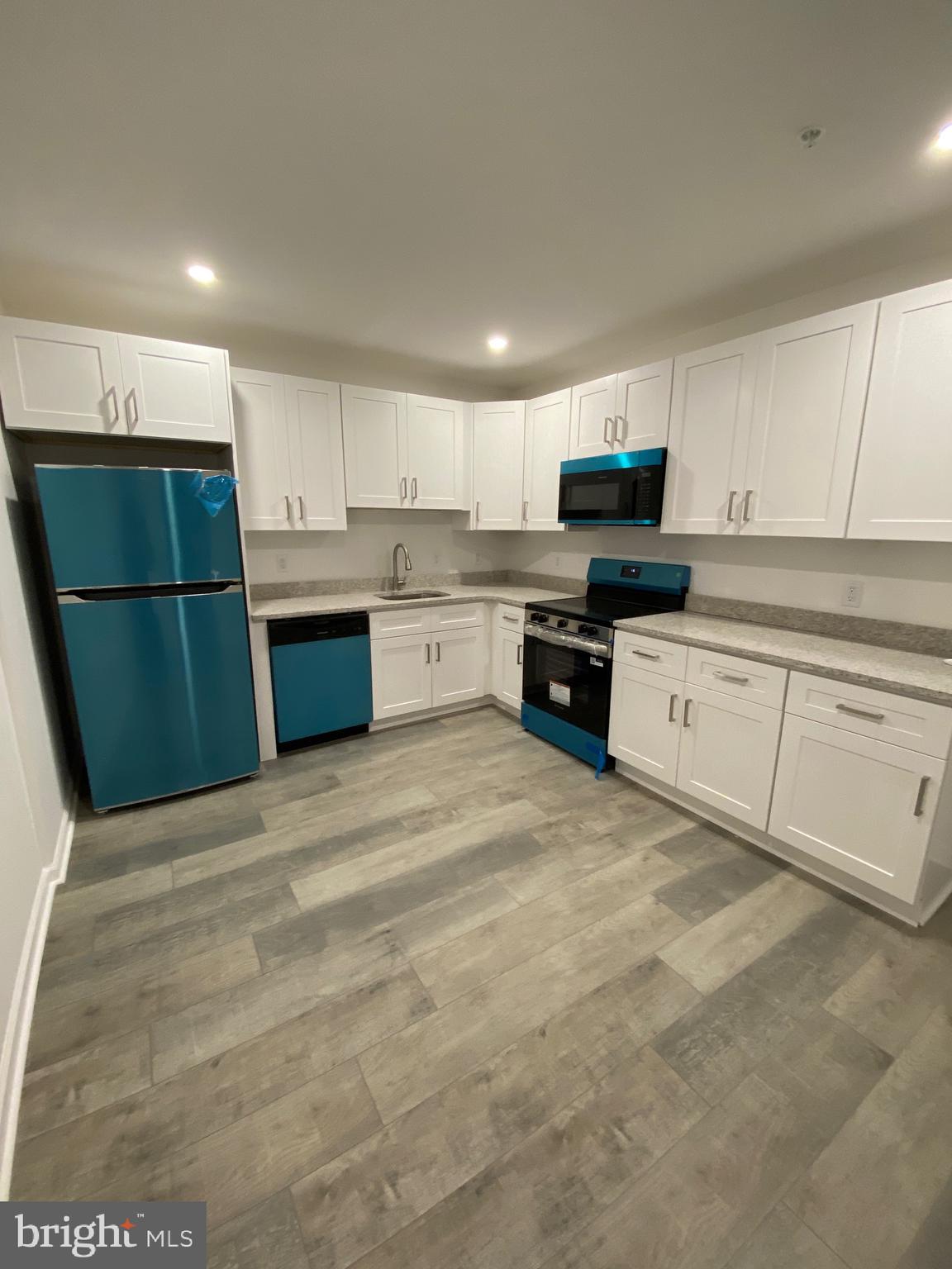 45 East High Street, Unit 1ST FLOOR/3 BEDROOM Pottstown, PA 19464 - Photo 9 of 25 a kitchen with a refrigerator and a stove top oven