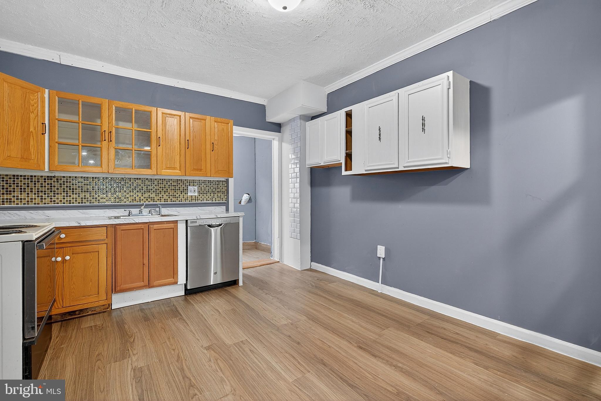 2202 Ashton Street Baltimore, MD 21223 - Photo 11 of 35 a kitchen with granite countertop wooden cabinets and a wooden floor