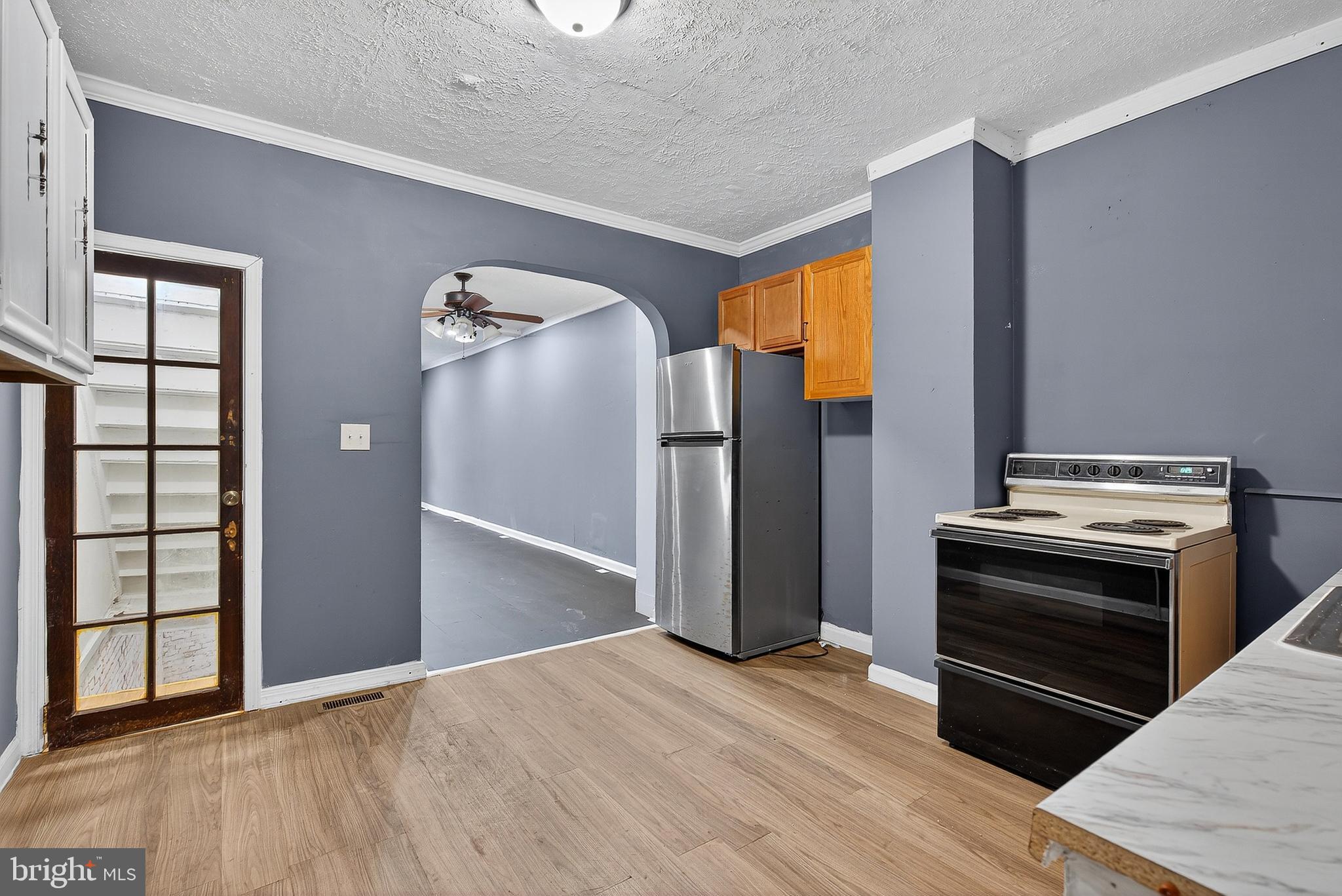 2202 Ashton Street Baltimore, MD 21223 - Photo 13 of 35 a view of an empty room with wooden floor and a window