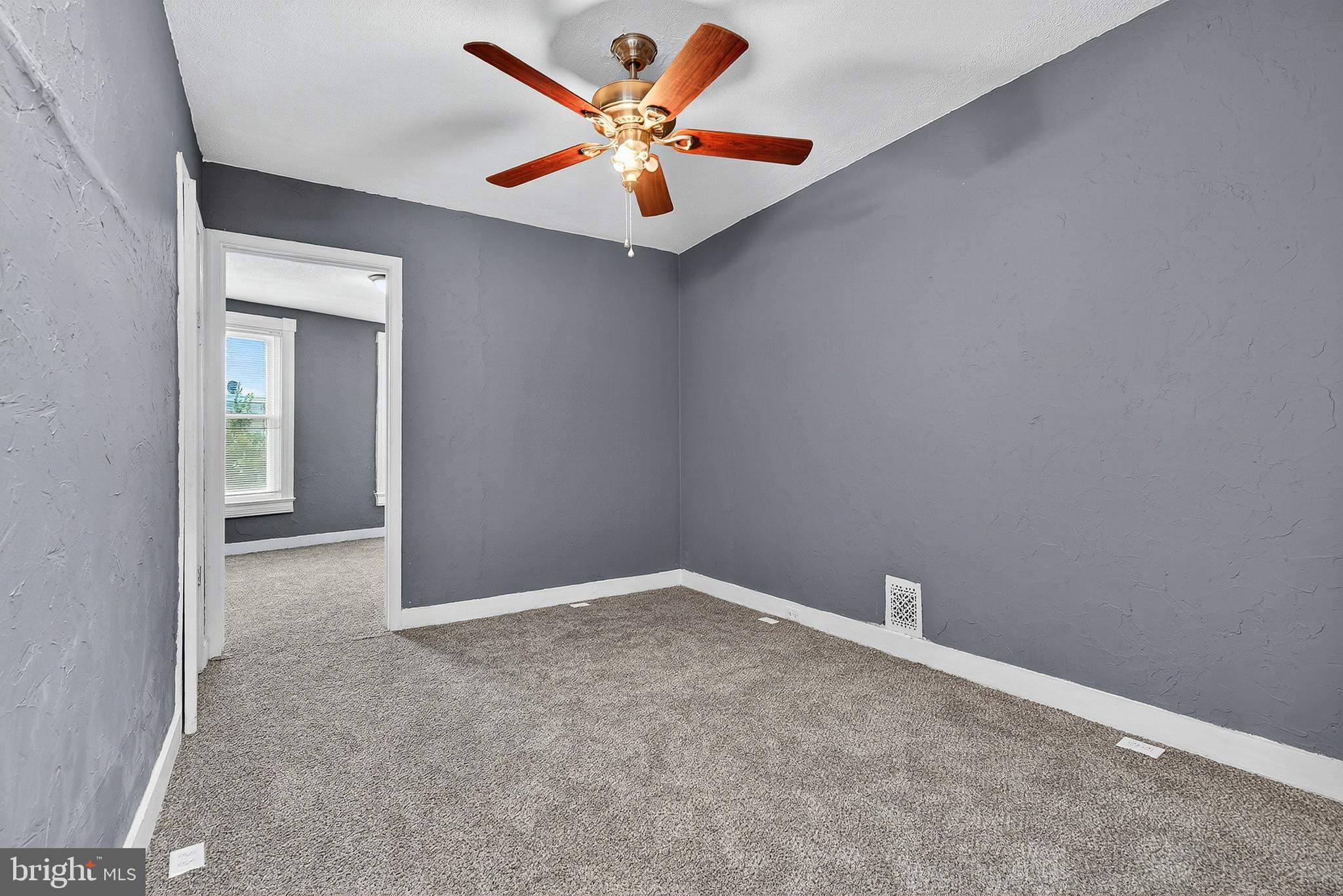 2202 Ashton Street Baltimore, MD 21223 - Photo 15 of 35 an empty room with a window and a ceiling fan