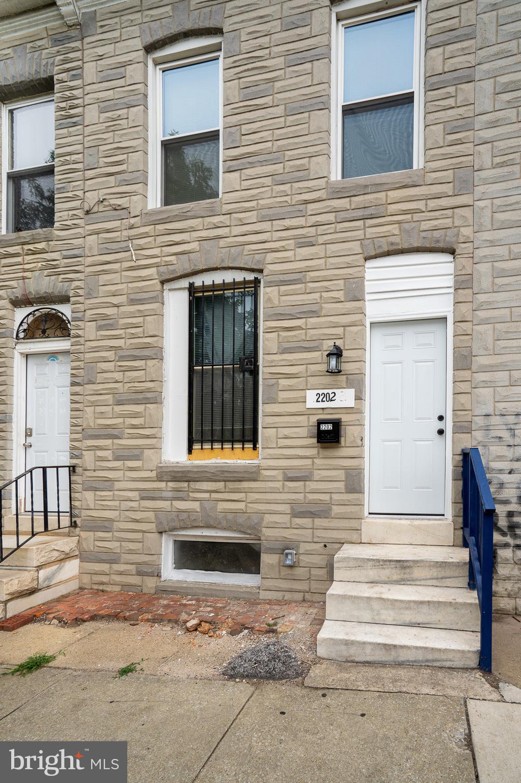 2202 Ashton Street Baltimore, MD 21223 - Photo 4 of 35 a front view of a house with stairs