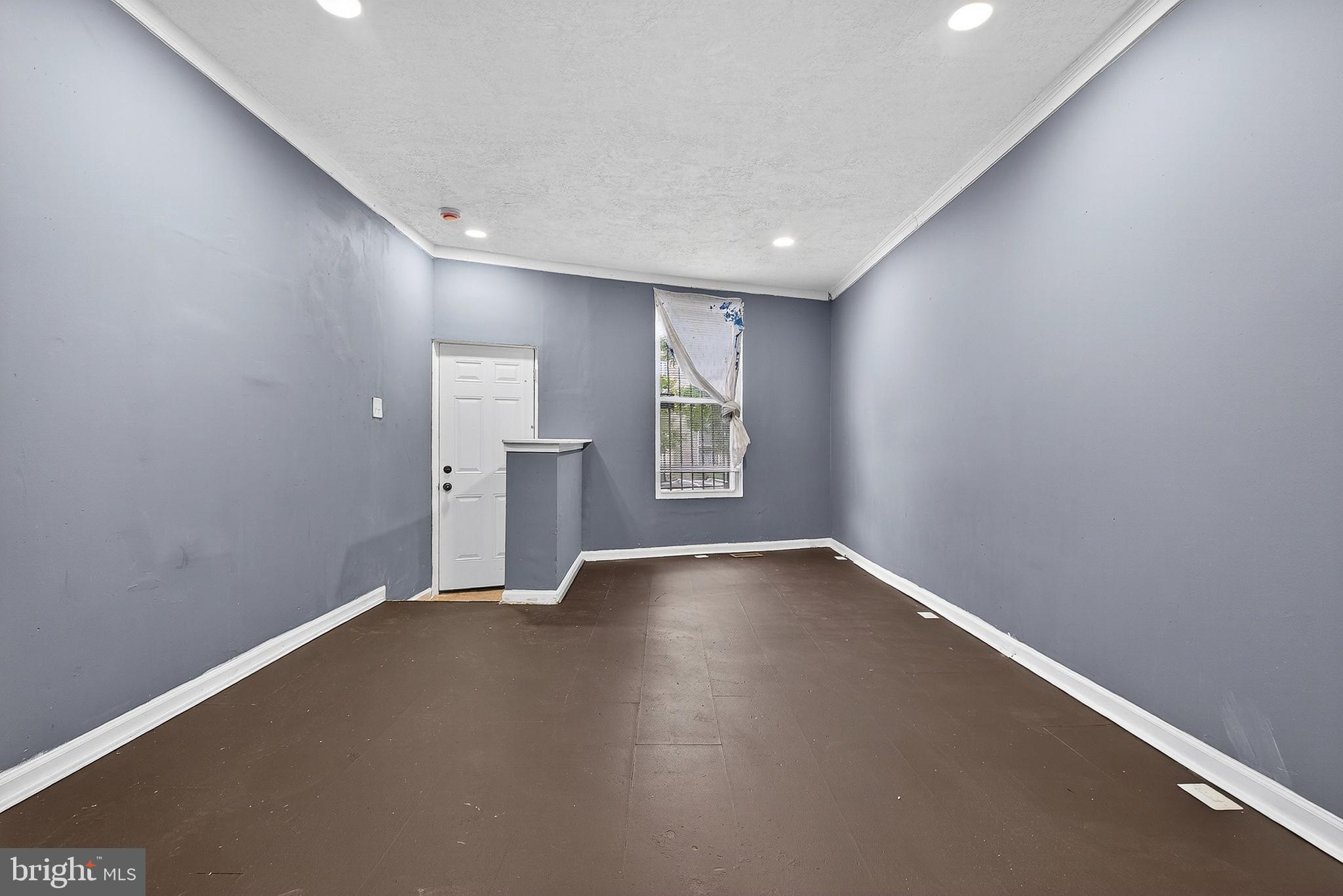 2202 Ashton Street Baltimore, MD 21223 - Photo 5 of 35 an empty room with wooden floor and windows