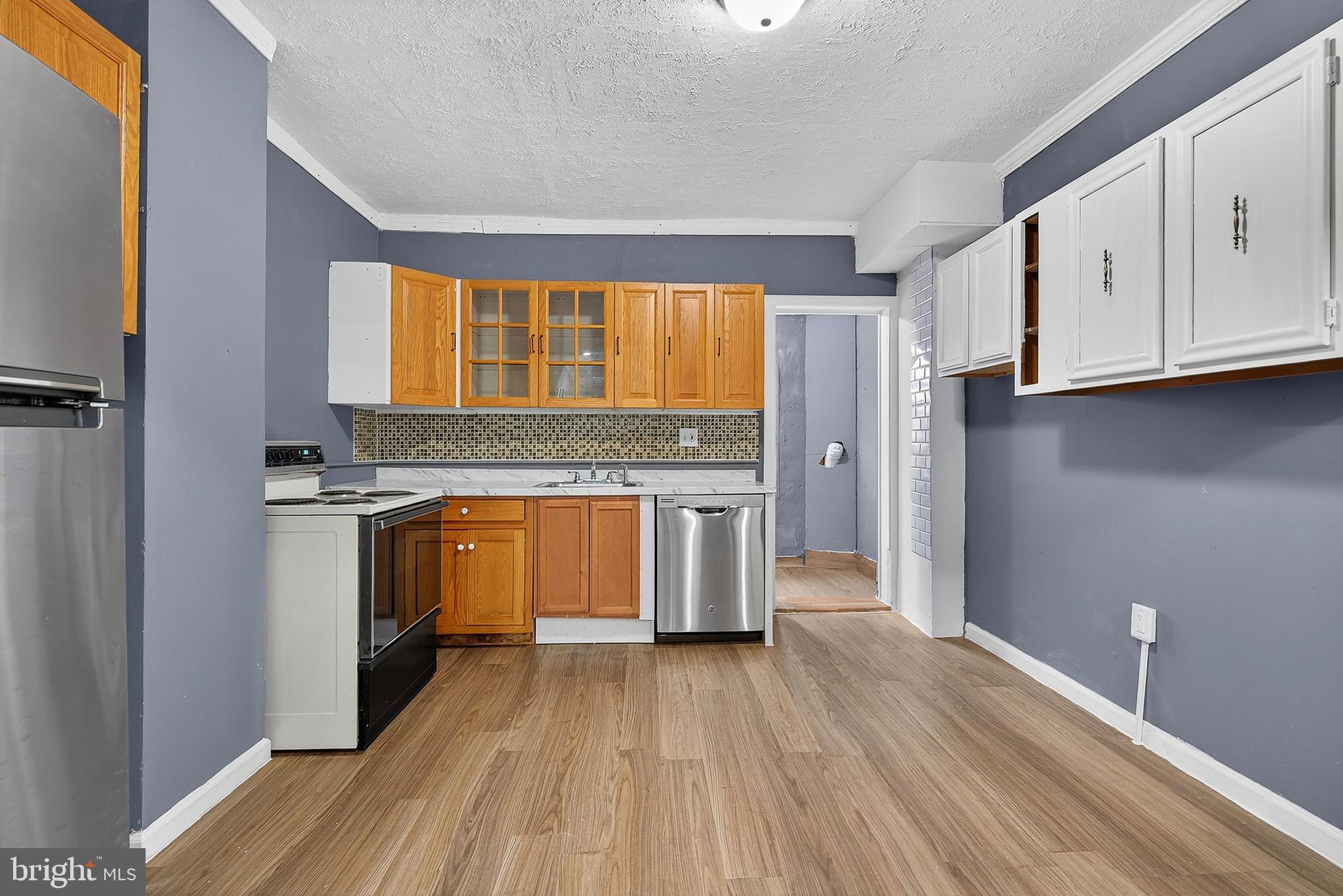 2202 Ashton Street Baltimore, MD 21223 - Photo 10 of 35 a view of kitchen with granite countertop cabinets and wooden floor