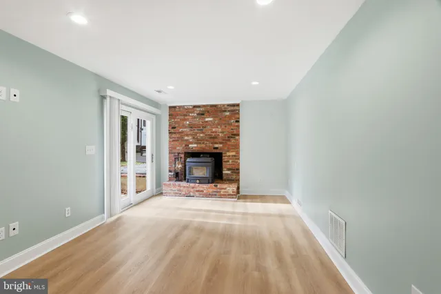 a view of an empty room with a fireplace