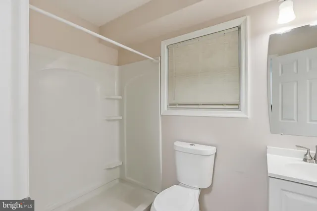 a bathroom with a toilet sink and shower