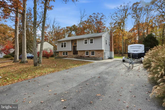a view of a house with a yard covered in snow