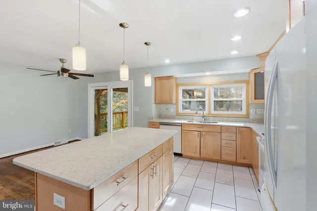 a kitchen with a stove a sink and a refrigerator