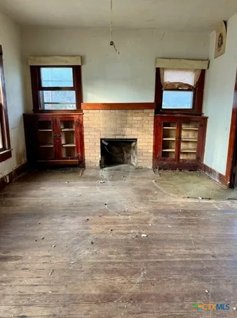 an empty room with furniture and a fireplace
