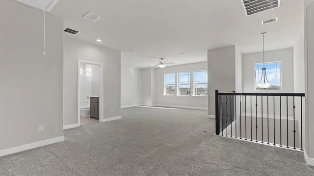 a view of a hallway with wooden floor and entryway