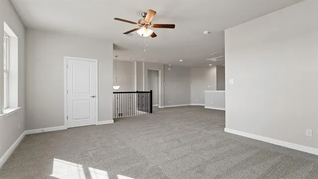an empty room with staircase and entryway