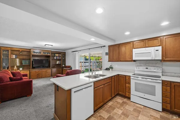 a kitchen with granite countertop cabinets stainless steel appliances and a sink