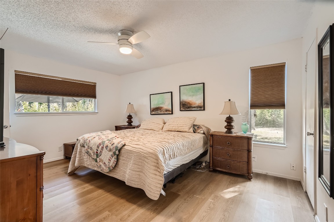 9206 Robins Nest Lane Austin, TX 78729 - Photo 9 of 18 a bedroom with a bed and a window