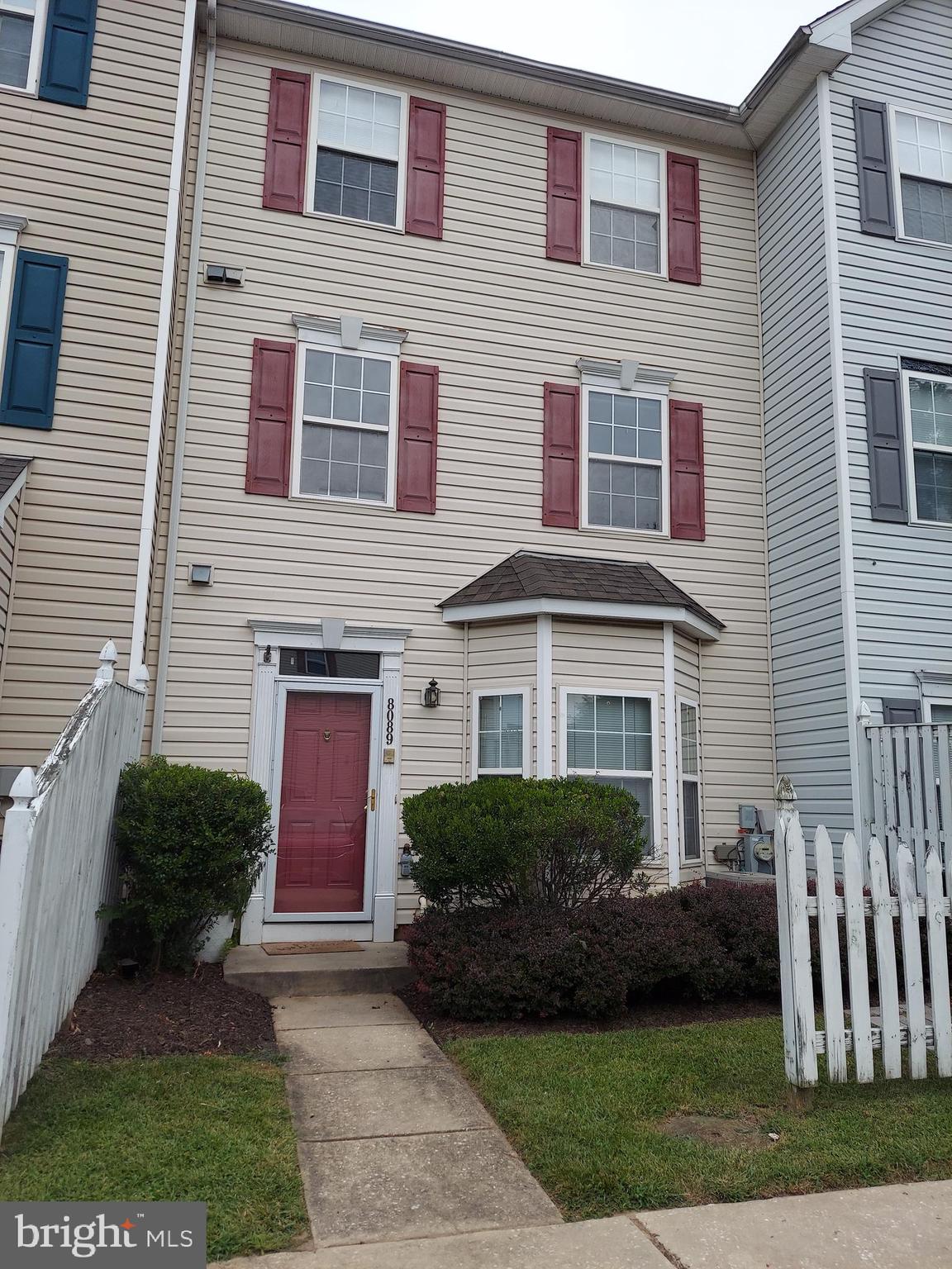 8089 Brookstone Court Severn, MD 21144 - Photo 1 of 33 a front view of a house with a garden