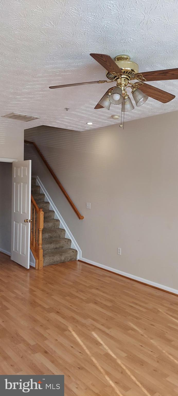 8089 Brookstone Court Severn, MD 21144 - Photo 13 of 33 a view of a room with wooden floor and staircase
