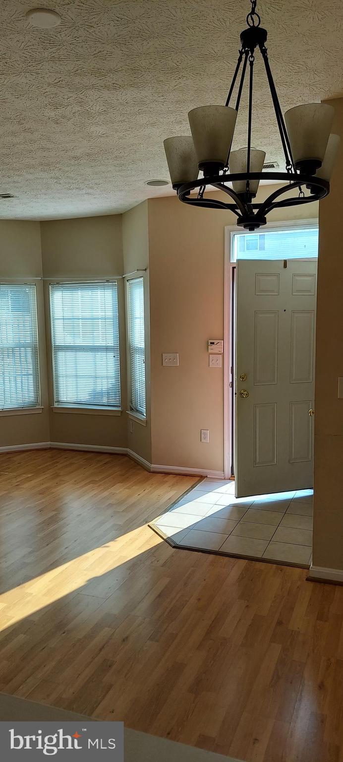 8089 Brookstone Court Severn, MD 21144 - Photo 14 of 33 a view of a room with wooden floor and window