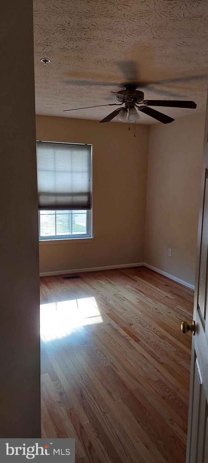 8089 Brookstone Court Severn, MD 21144 - Photo 18 of 33 a view of a room with wooden floor and a window