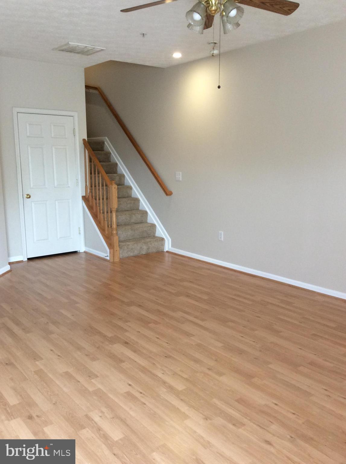 8089 Brookstone Court Severn, MD 21144 - Photo 4 of 33 a view of a room with wooden floor and white walls