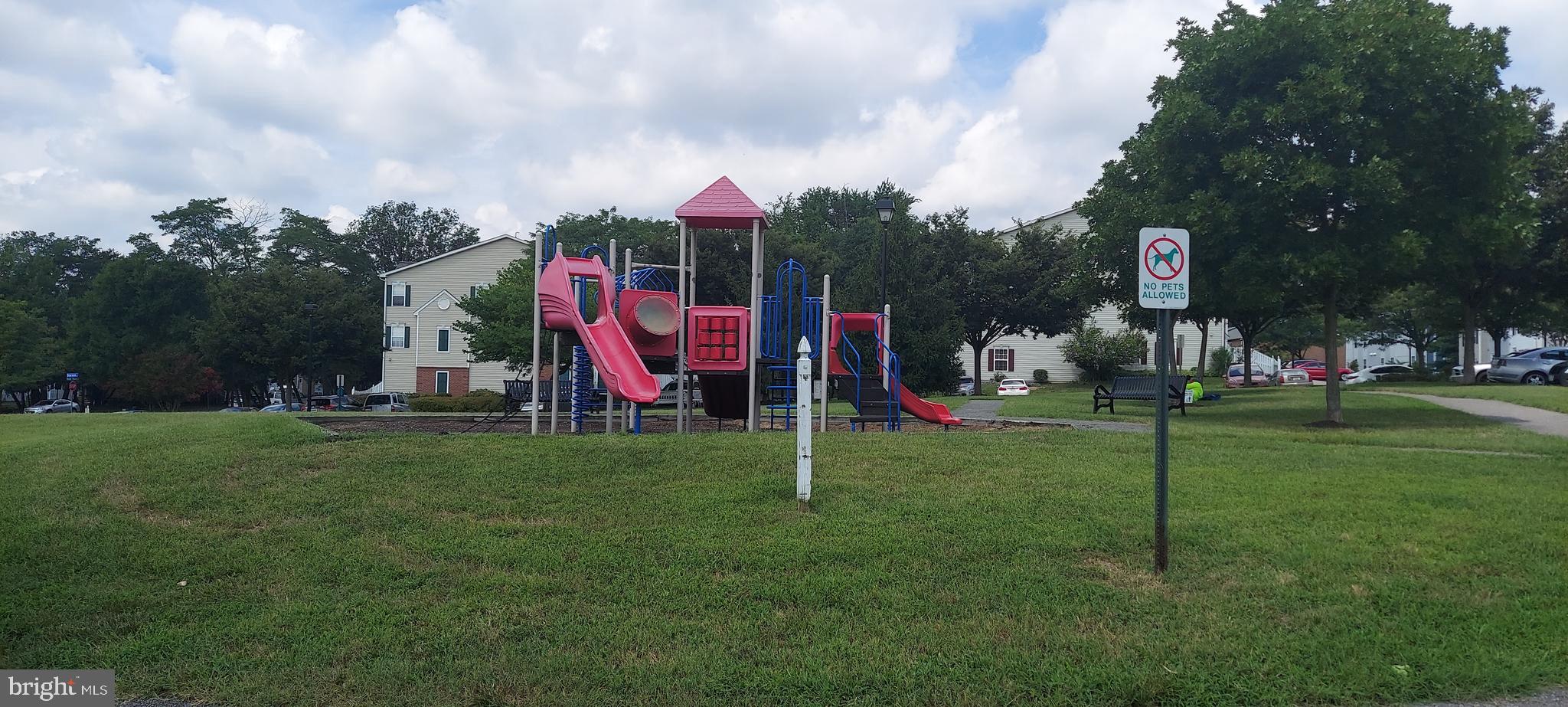 8089 Brookstone Court Severn, MD 21144 - Photo 5 of 33 a view of a park with swings and slides