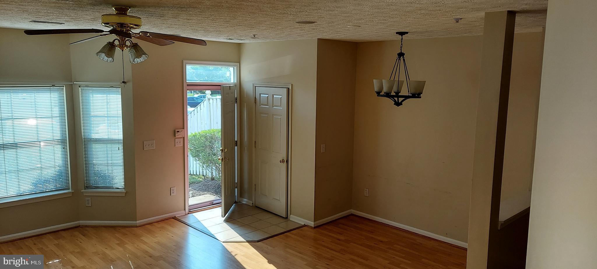 8089 Brookstone Court Severn, MD 21144 - Photo 8 of 33 a view of a hallway with wooden floor and a carpet