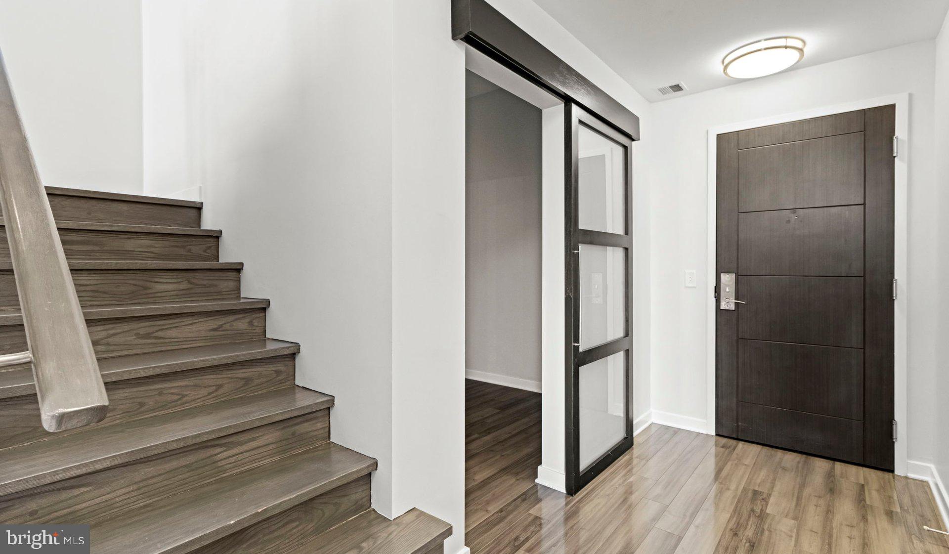 8300 Wisconsin Avenue, Unit 1B1836 Bethesda, MD 20814 - Photo 120 of 150 a view of entryway with wooden floor and stairs