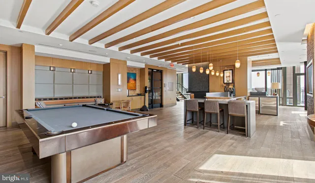 a room with pool table and glass windows