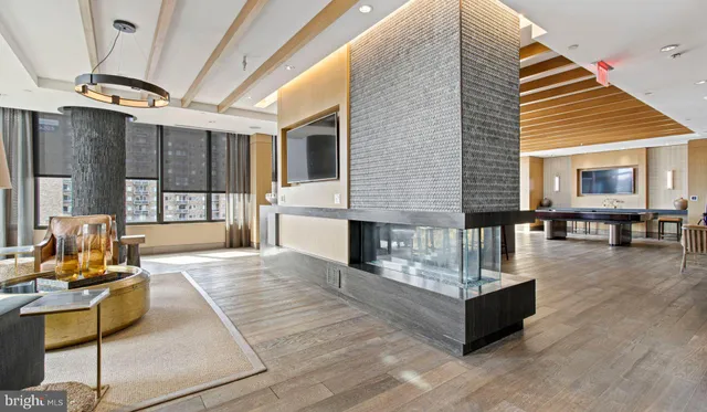 a living room with furniture and a floor to ceiling window