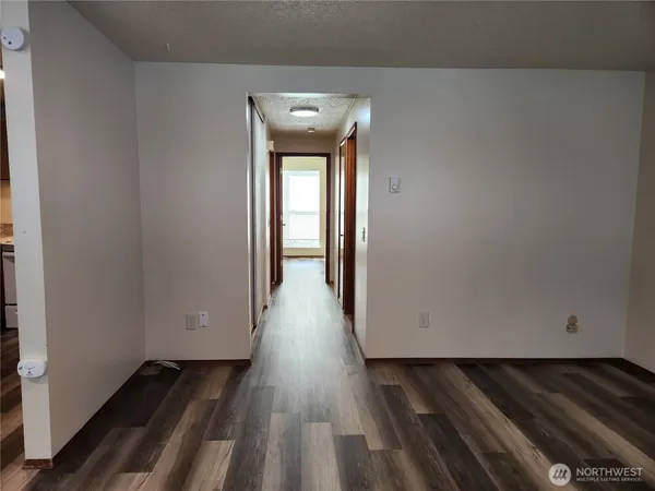 a view of a room with wooden floor