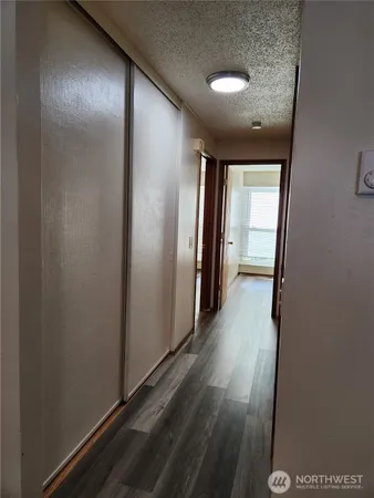 a view of hallway with stairs and wooden floor