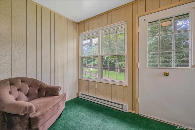 a view of a hallway with wooden floor and closet area