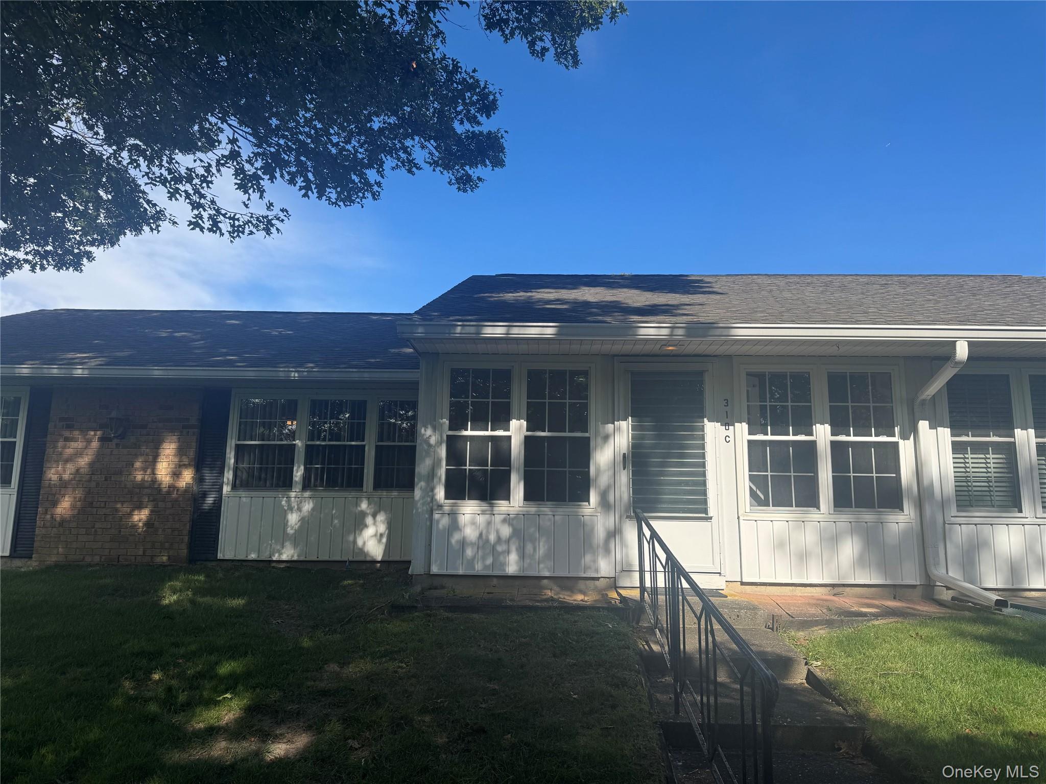 310 C Woodbridge Drive Ridge, NY 11961 - Photo 18 of 24 a front view of a house with a garden