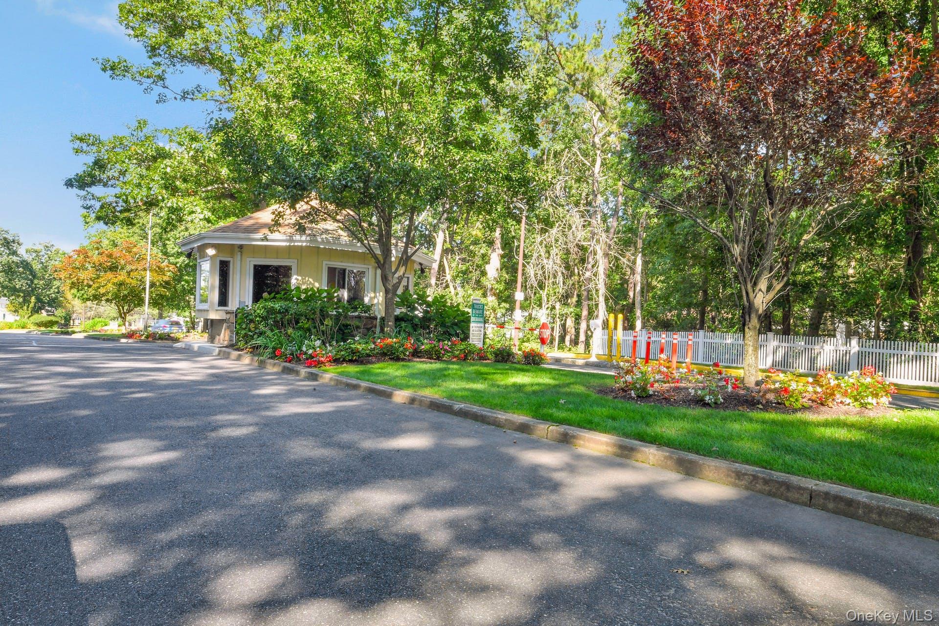 310 C Woodbridge Drive Ridge, NY 11961 - Photo 23 of 24 a front view of a house with a garden and plants
