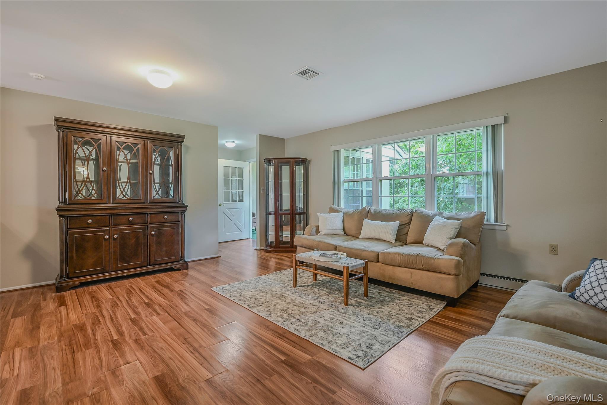 310 C Woodbridge Drive Ridge, NY 11961 - Photo 3 of 24 a living room with furniture and a wooden floor