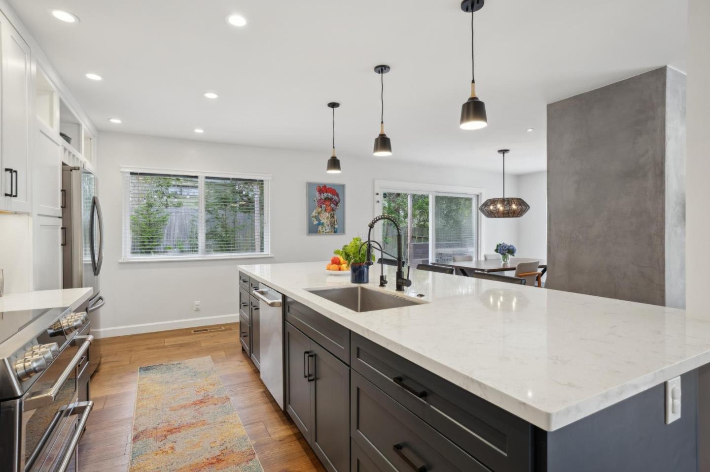 4095 Sunset Lane Pebble Beach, CA 93953 - Photo 12 of 55 a kitchen with stainless steel appliances a stove a sink a center island and windows