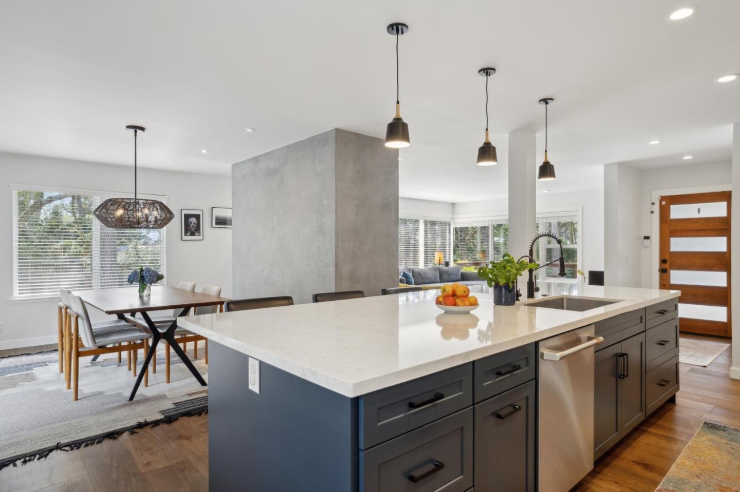 4095 Sunset Lane Pebble Beach, CA 93953 - Photo 17 of 55 a kitchen with stainless steel appliances kitchen island granite countertop a table chairs and a wooden floor