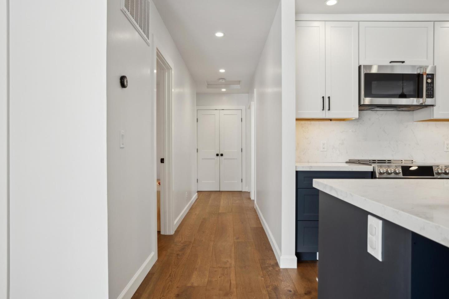 4095 Sunset Lane Pebble Beach, CA 93953 - Photo 20 of 55 a kitchen with a sink and a stove top oven with wooden floor