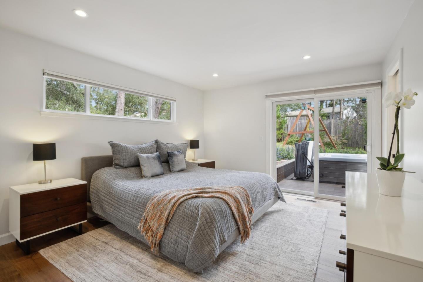 4095 Sunset Lane Pebble Beach, CA 93953 - Photo 21 of 55 a bedroom with a large bed and a balcony view