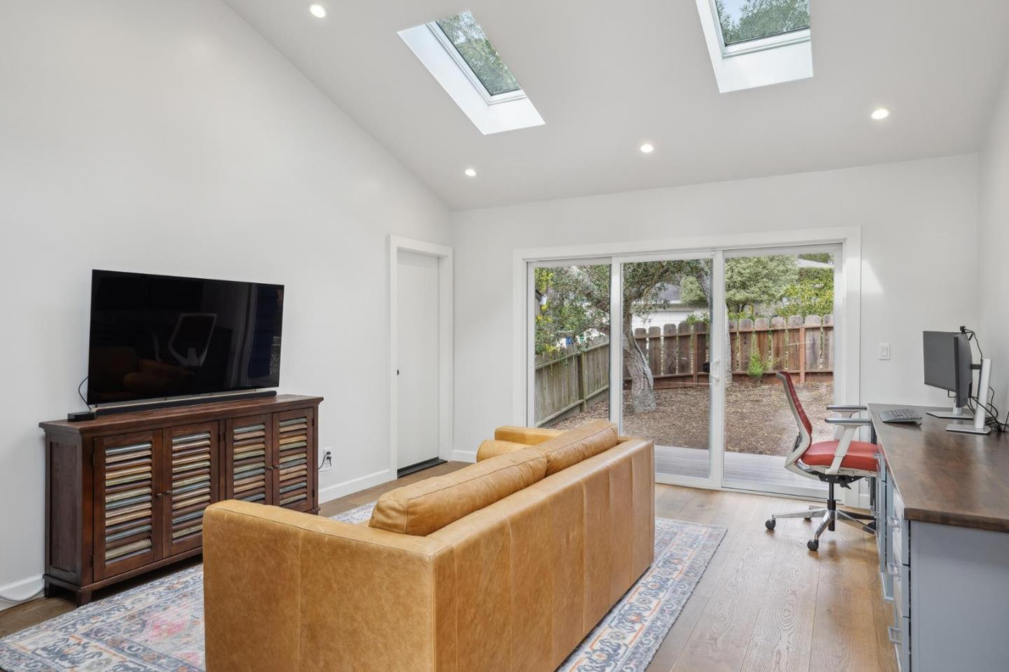 4095 Sunset Lane Pebble Beach, CA 93953 - Photo 33 of 55 a living room with furniture a flat screen tv and a fireplace