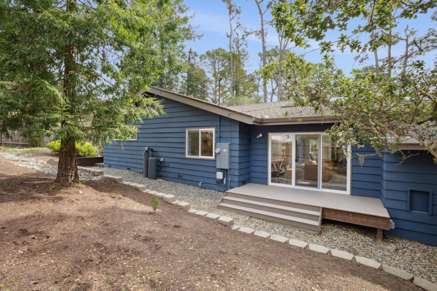 4095 Sunset Lane Pebble Beach, CA 93953 - Photo 45 of 55 a front view of a house with a garden and trees