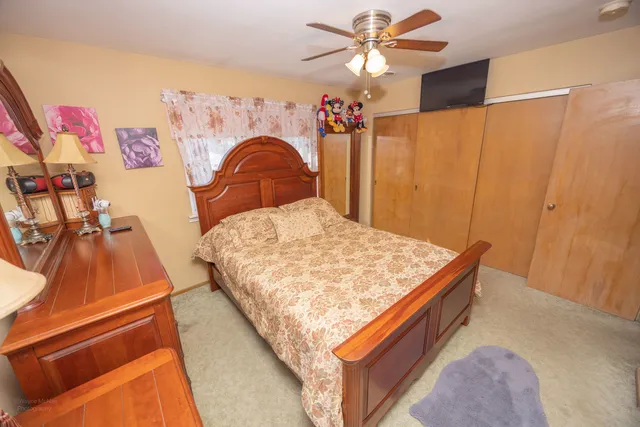 a bed sitting in a bedroom next to a window