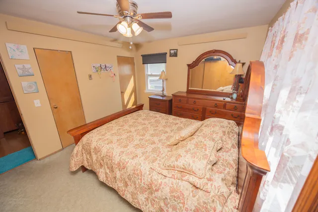 a bedroom with a bed and a dresser