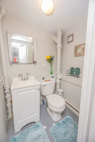 a bathroom with a sink toilet and mirror