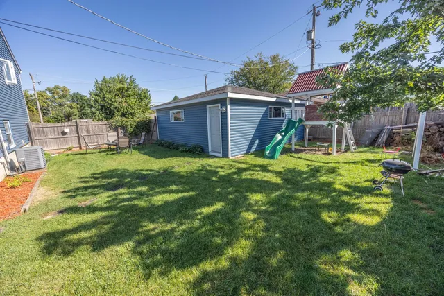 a view of a backyard with table and chairs and potted plants