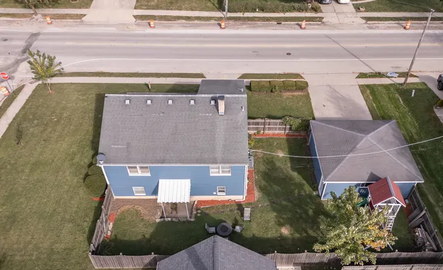 a view of a brick house with potted plants