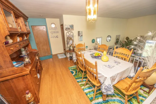 a view of a dining room with furniture and a chandelier